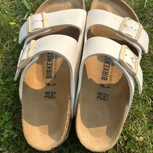 Birkenstock size 38 (Size 8 women). White with off-white colored buckles.